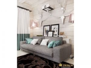серый лаконичный диван с белыми и бирюзовыми подушками. белый пол и темно-коричневый ковер